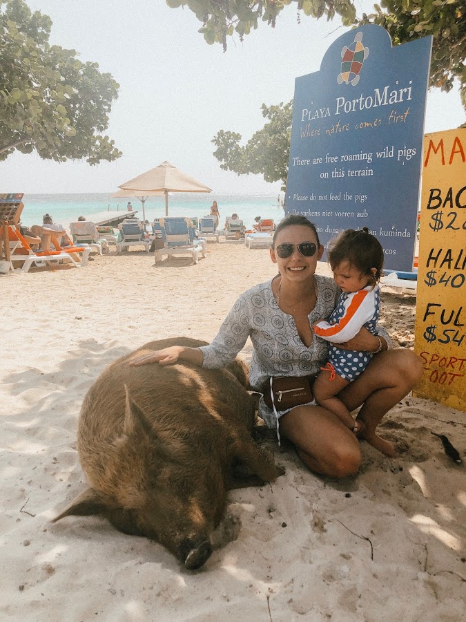 Summer and her baby with one of the beach pigs at Playa Porto Mari, Curaçao
