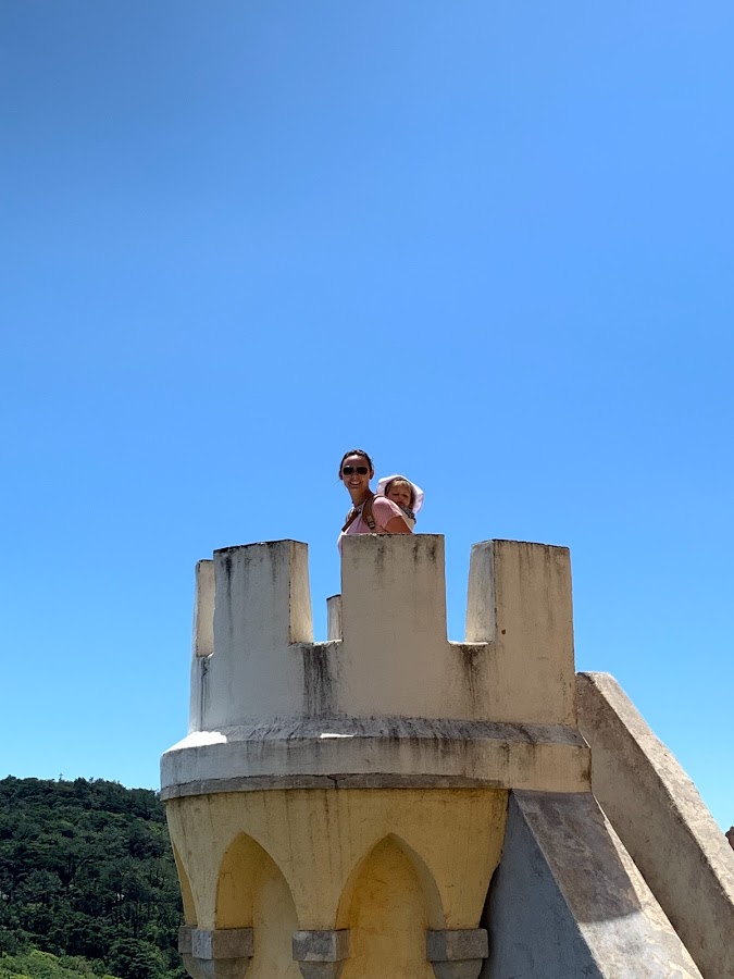 Summer and her daughter on top of a yellow turret at Pena Palace