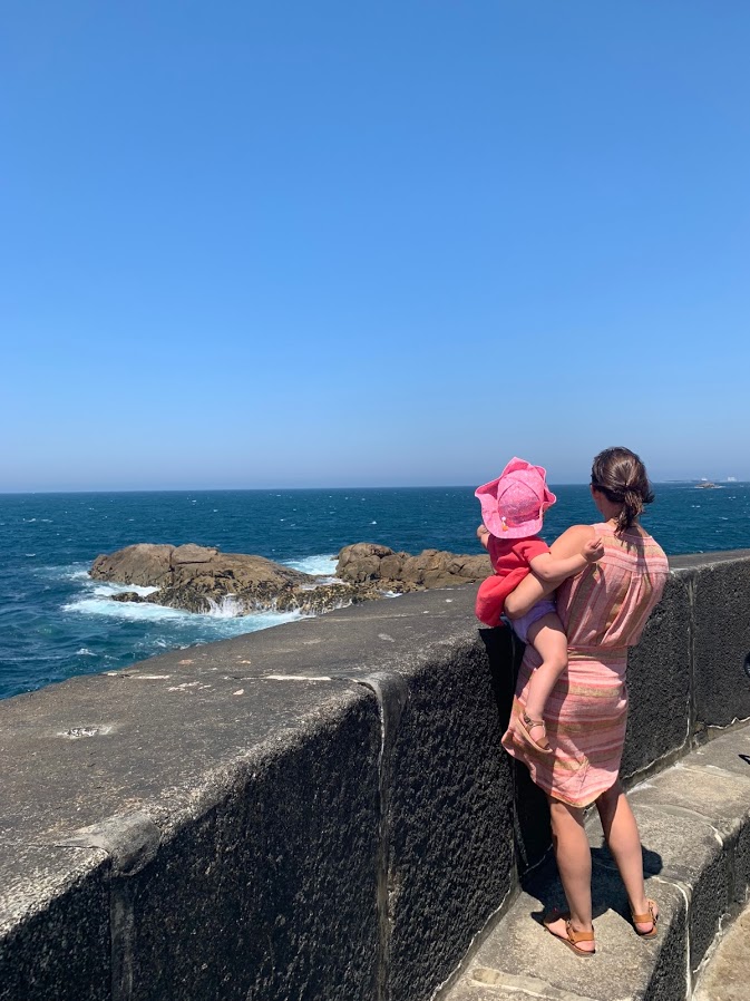 Summer holding her daughter on the sea wall at Foz do Douro
