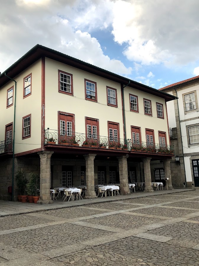 Historic buildings with balconies on a cobbled square in Guimarães old town