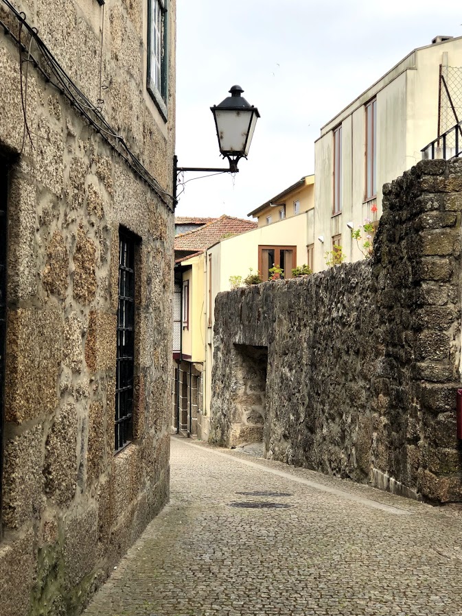 Quiet stone lane with a street lamp in Guimarães old town