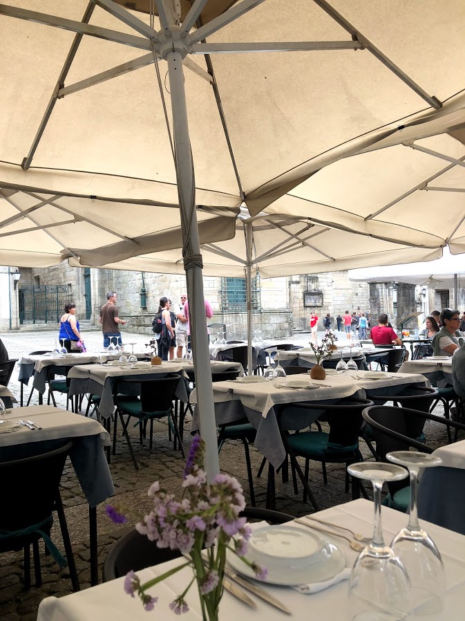 Outdoor tables under umbrellas in a Guimarães square