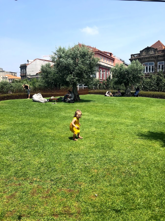 Toddler running on the lawn at Base Porto park