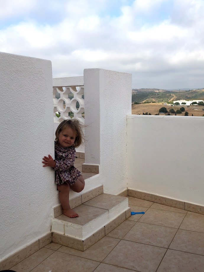 Toddler on the whitewashed terrace of our Airbnb in Aljezur