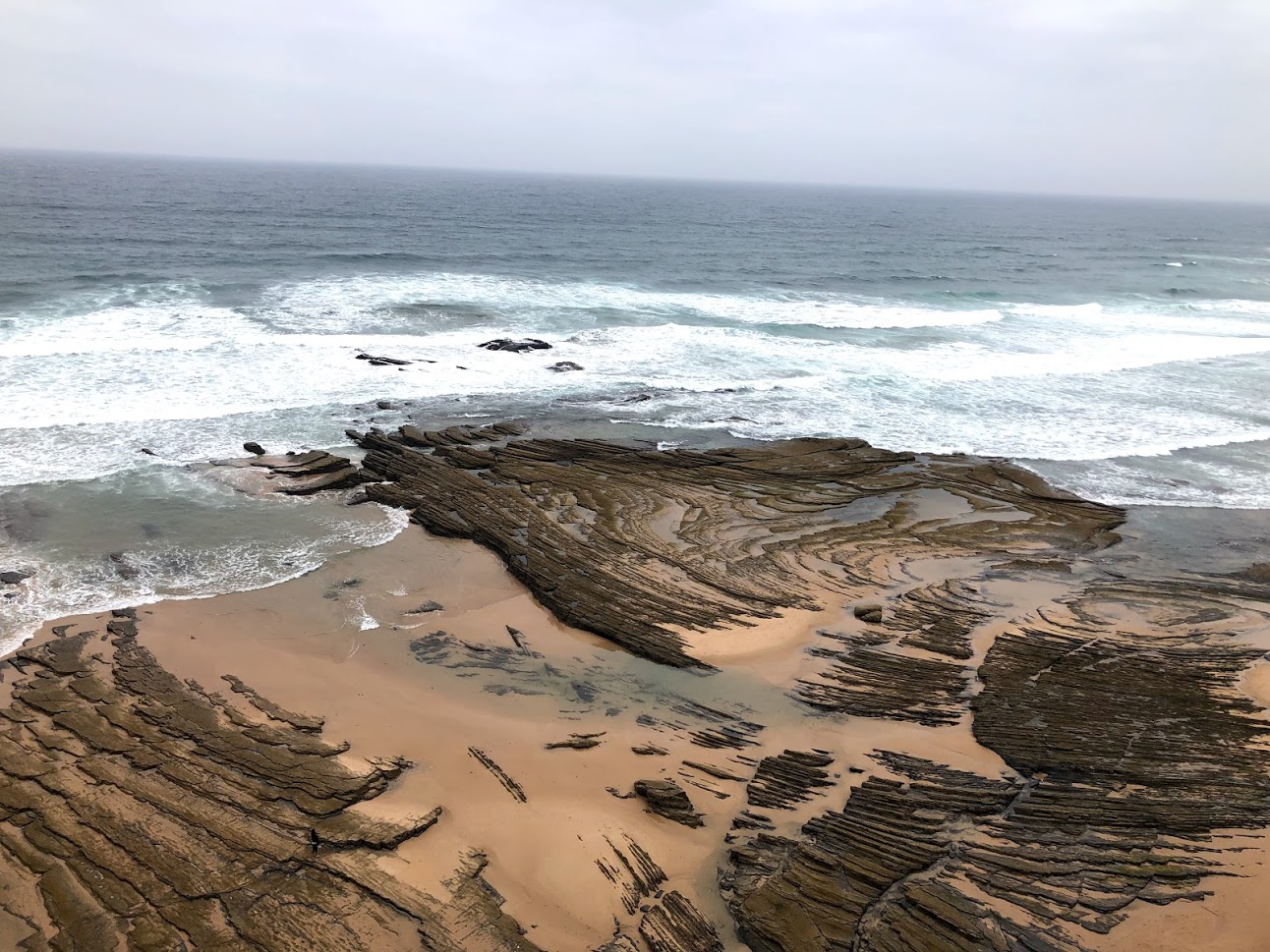 Rocky beach and Atlantic surf on the coast near Aljezur in the Algarve