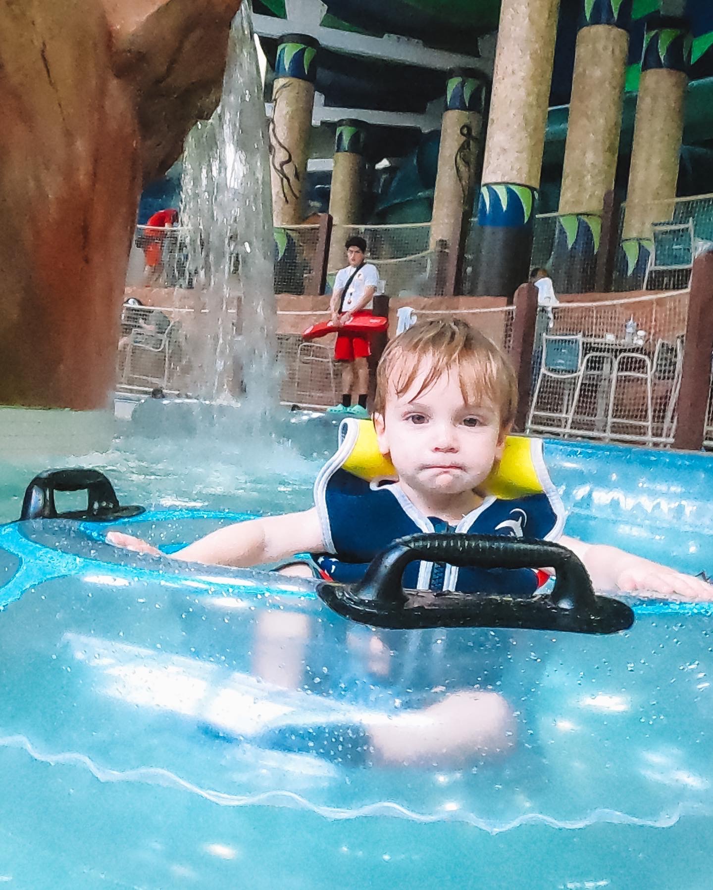 Toddler in a life jacket floating in the lazy river at Kalahari