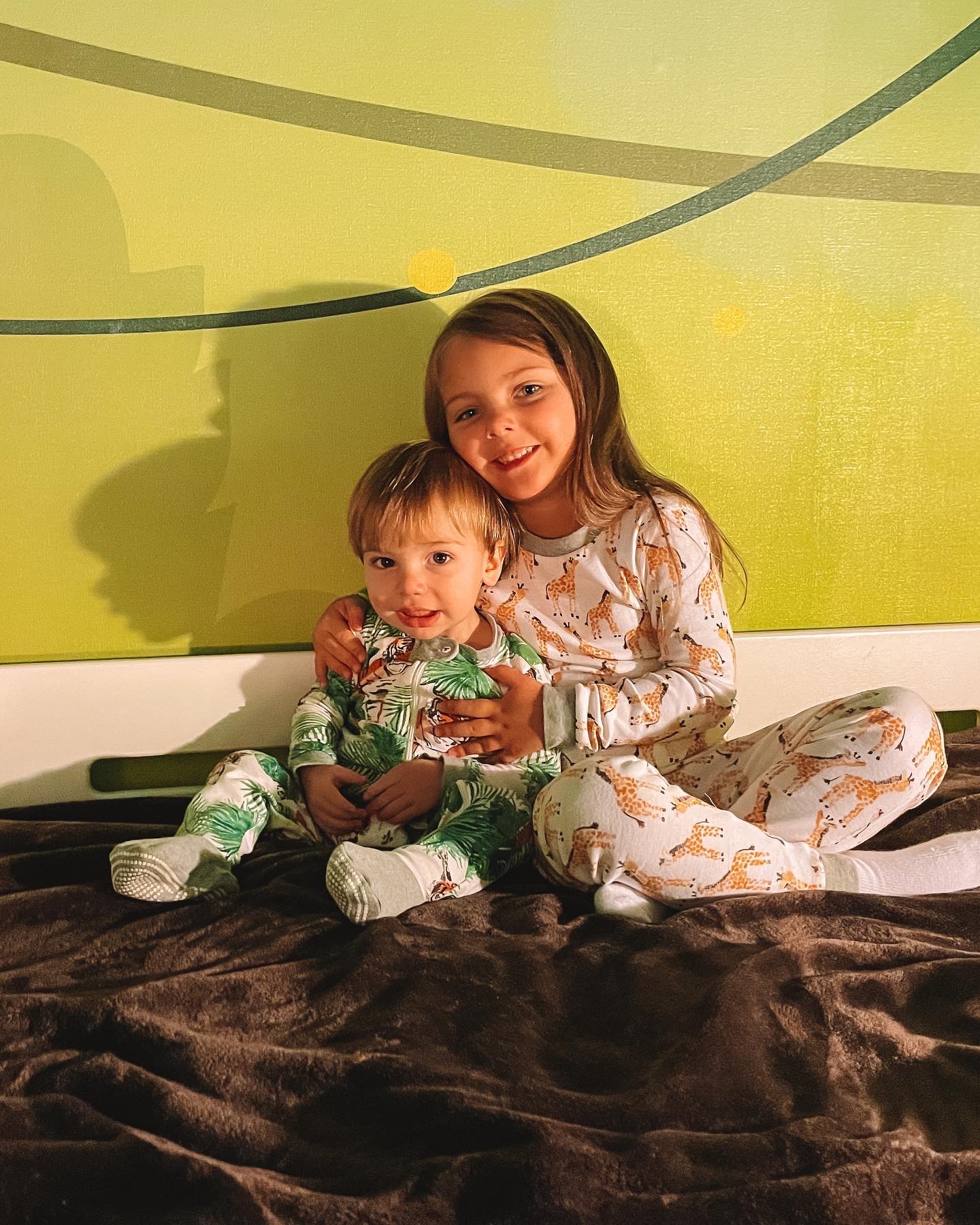 Summer's kids in pajamas on the safari bunk bed