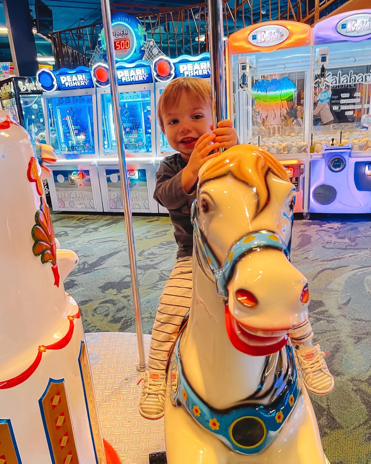 Toddler on a carousel horse in the Kalahari arcade