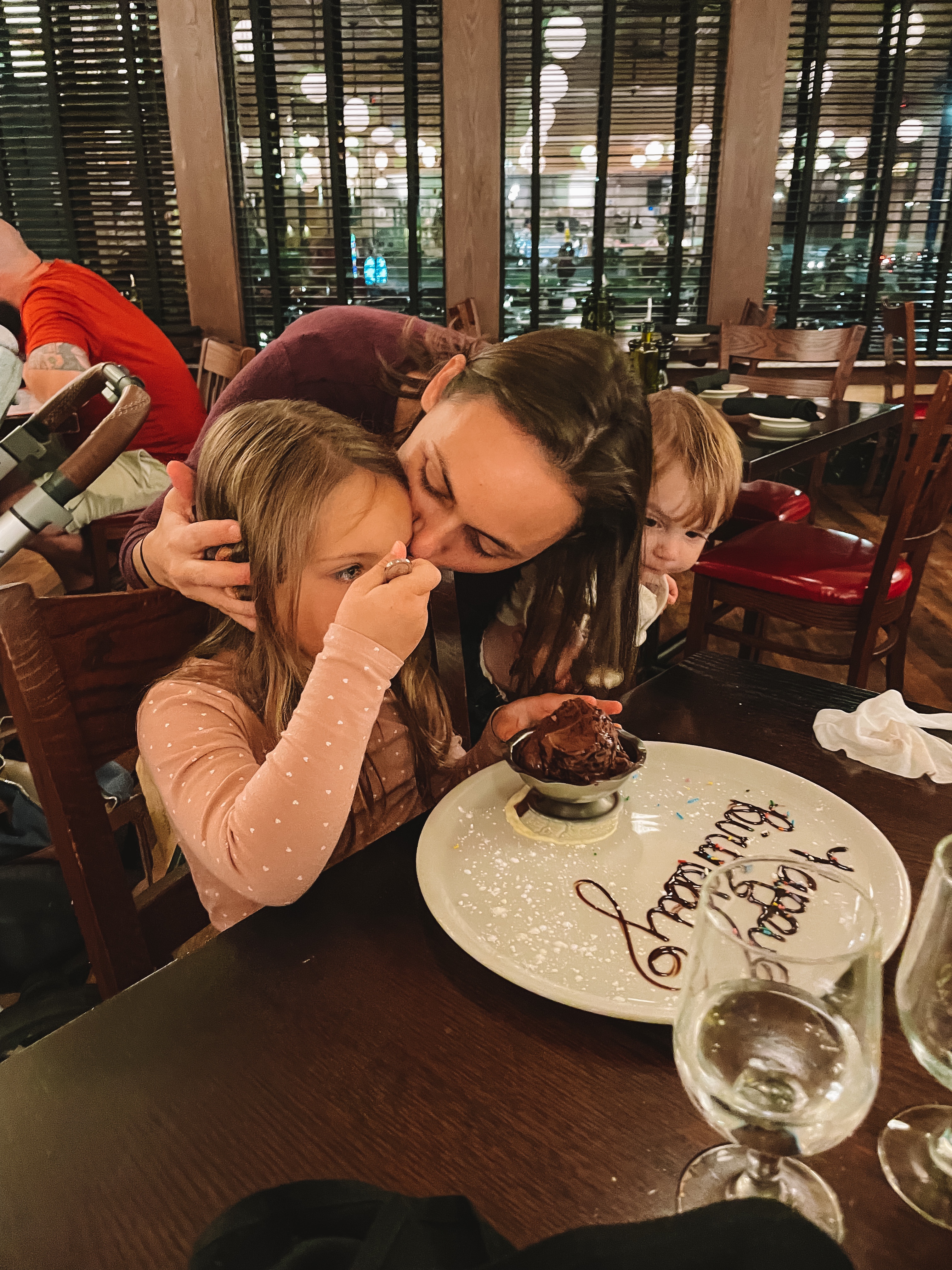 Summer kissing her daughter at her birthday dinner
