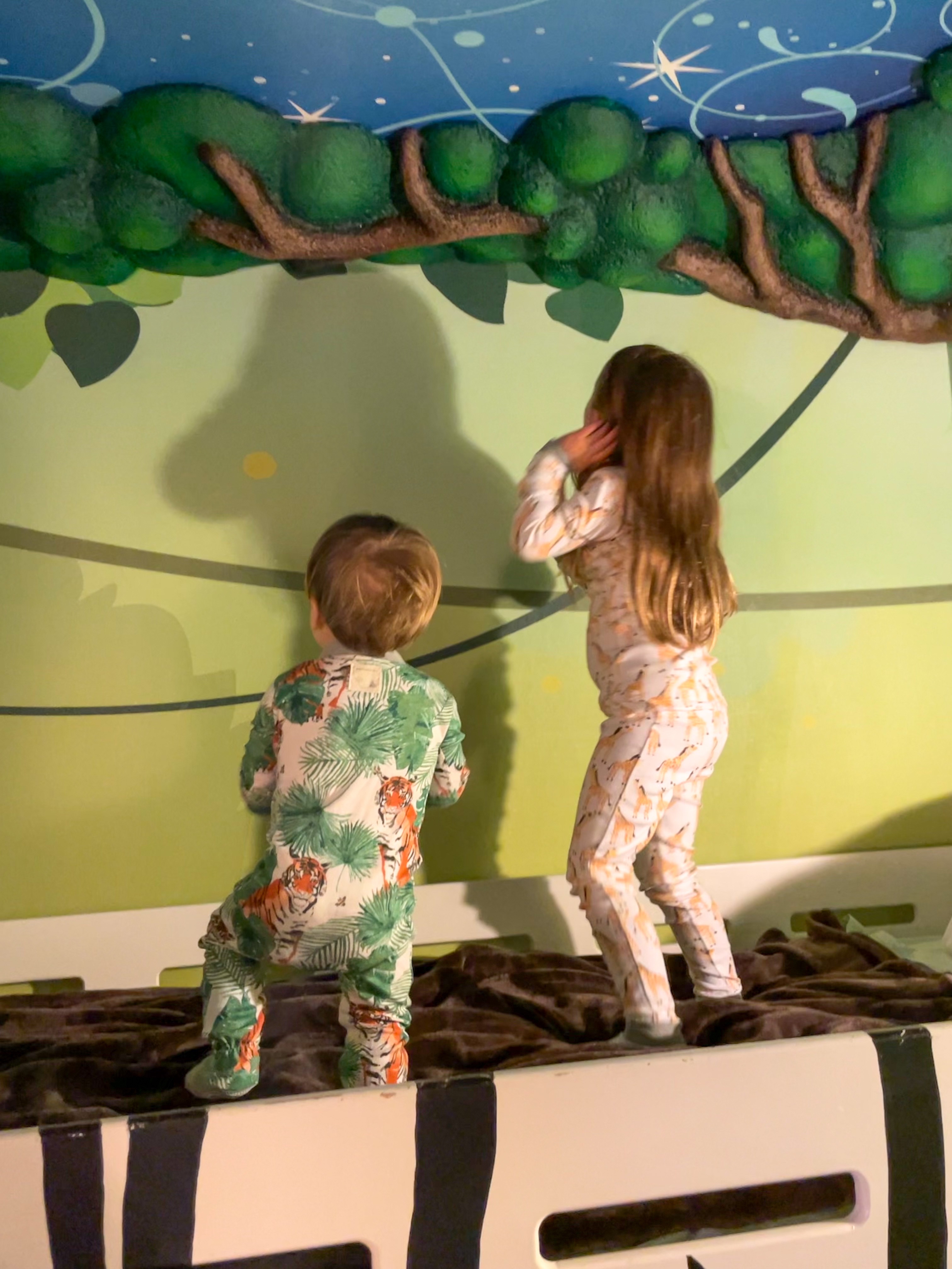 Summer's kids standing on the bunk bed in pajamas