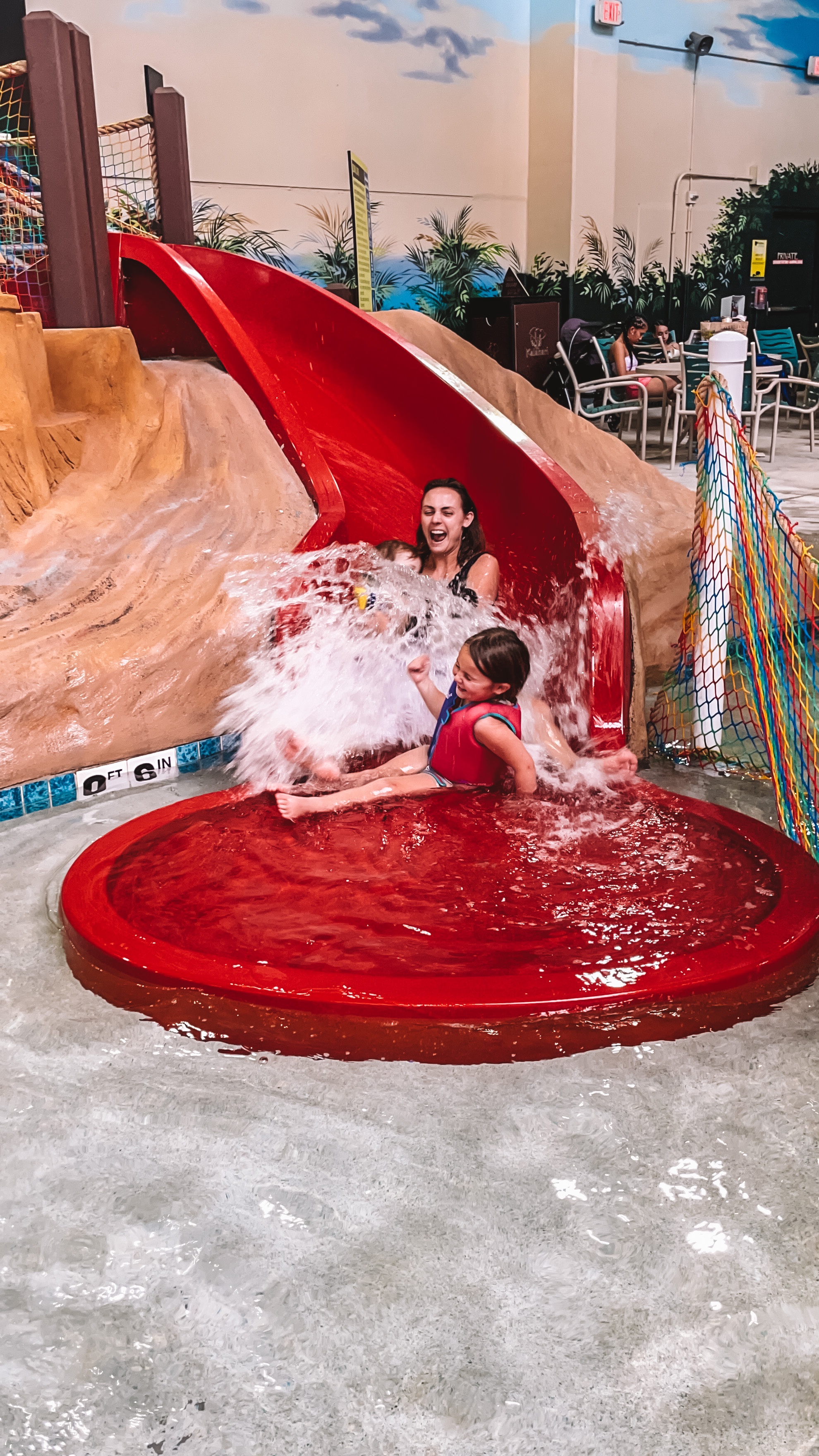 Summer's daughter splashing down a kids' slide at Kalahari