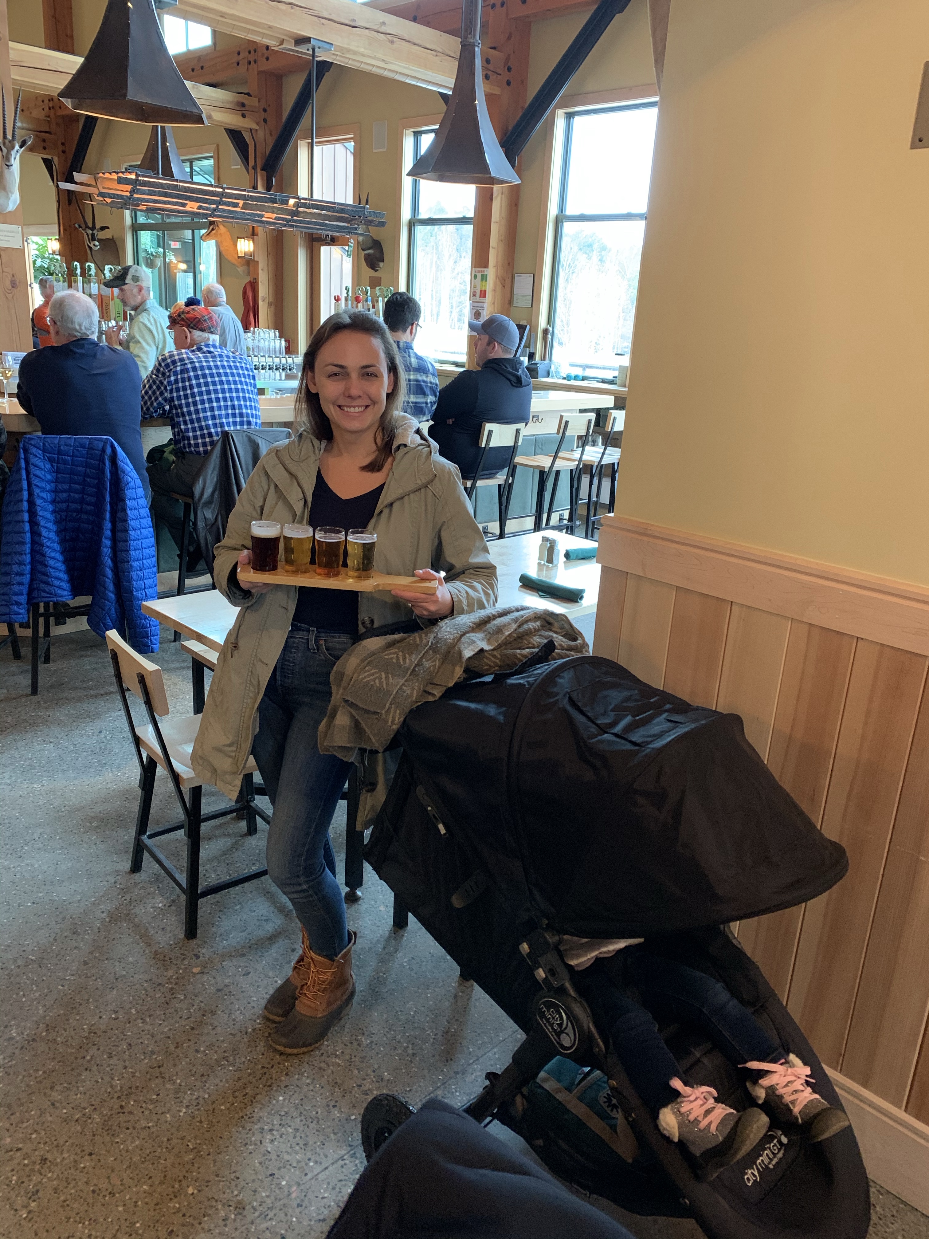 Summer carrying a beer flight at a Vermont brewery