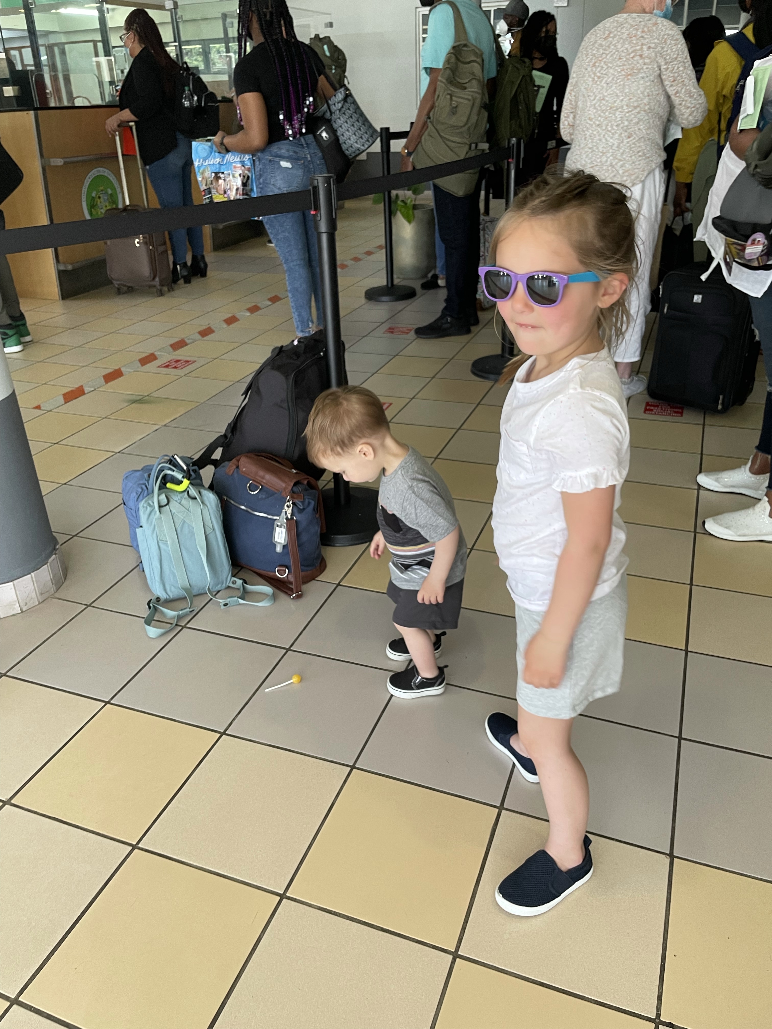 Summer's kids with their luggage in the check-in line