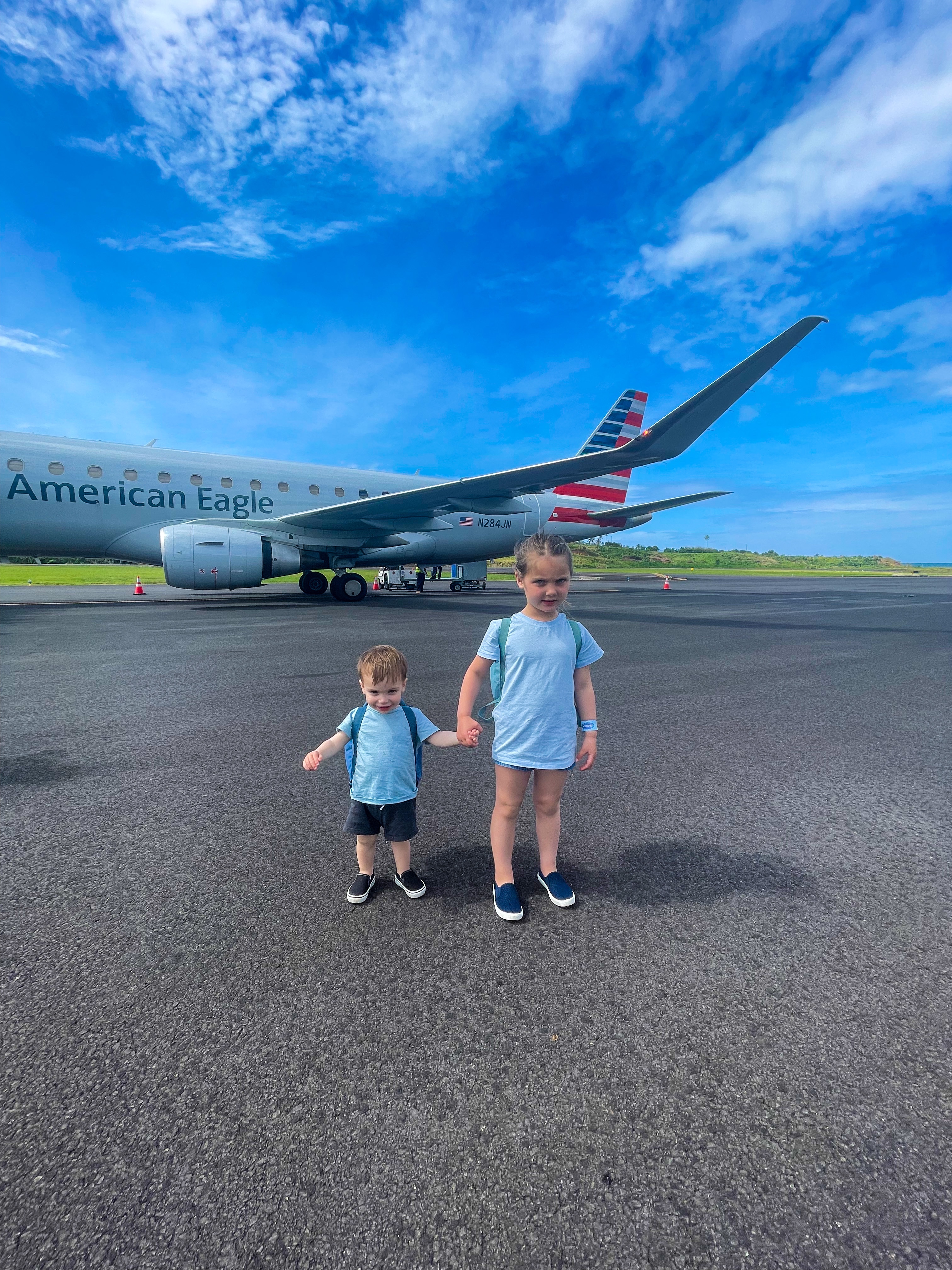 Summer's kids on the tarmac beside an American Airlines plane in Dominica
