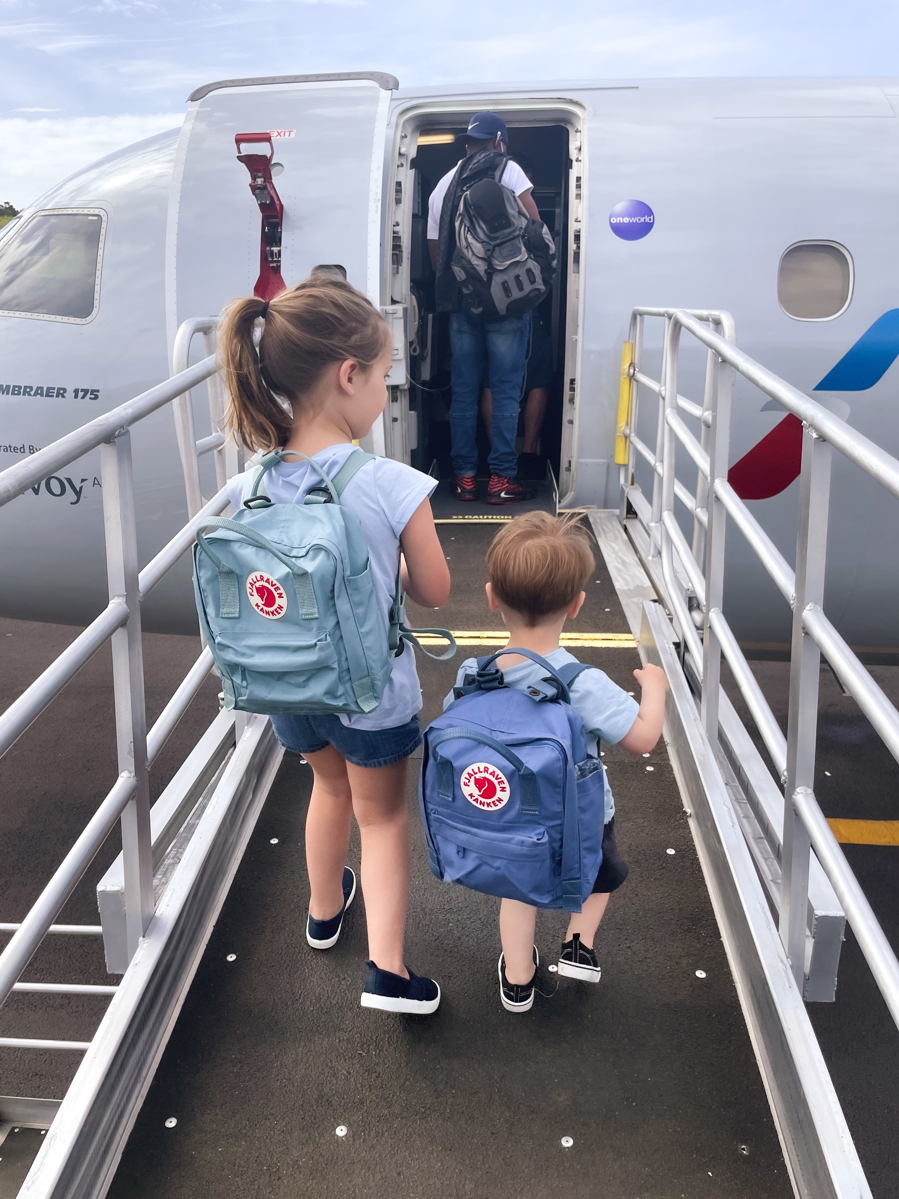 Summer's kids with their backpacks boarding a small plane