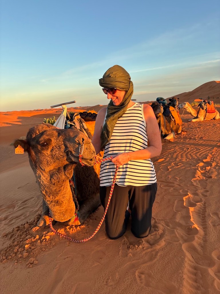 Amy Sinclair, Out Making Memories trip host, with a camel in the Sahara, Morocco