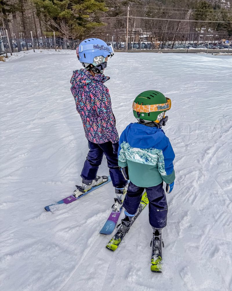Two kids skiing side by side at Attitash