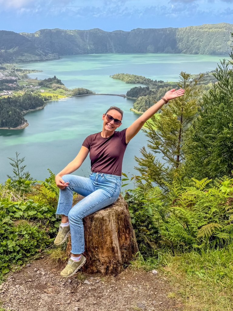 Summer Romeo, founder of Out Making Memories, waving from a viewpoint above the lakes of Sete Cidades, São Miguel, the Azores